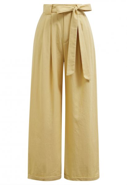 Pantalon large plissé avec ceinture à nœud papillon en moutarde