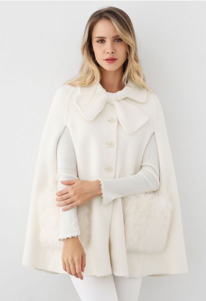 Manteau cape boutonné en tricot avec poche en fausse fourrure et décor de nœud papillon en crème