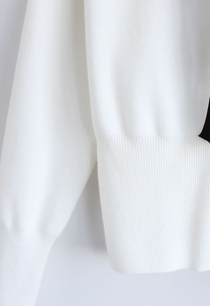 Pull en tricot boutonné avec nœud papillon en blanc