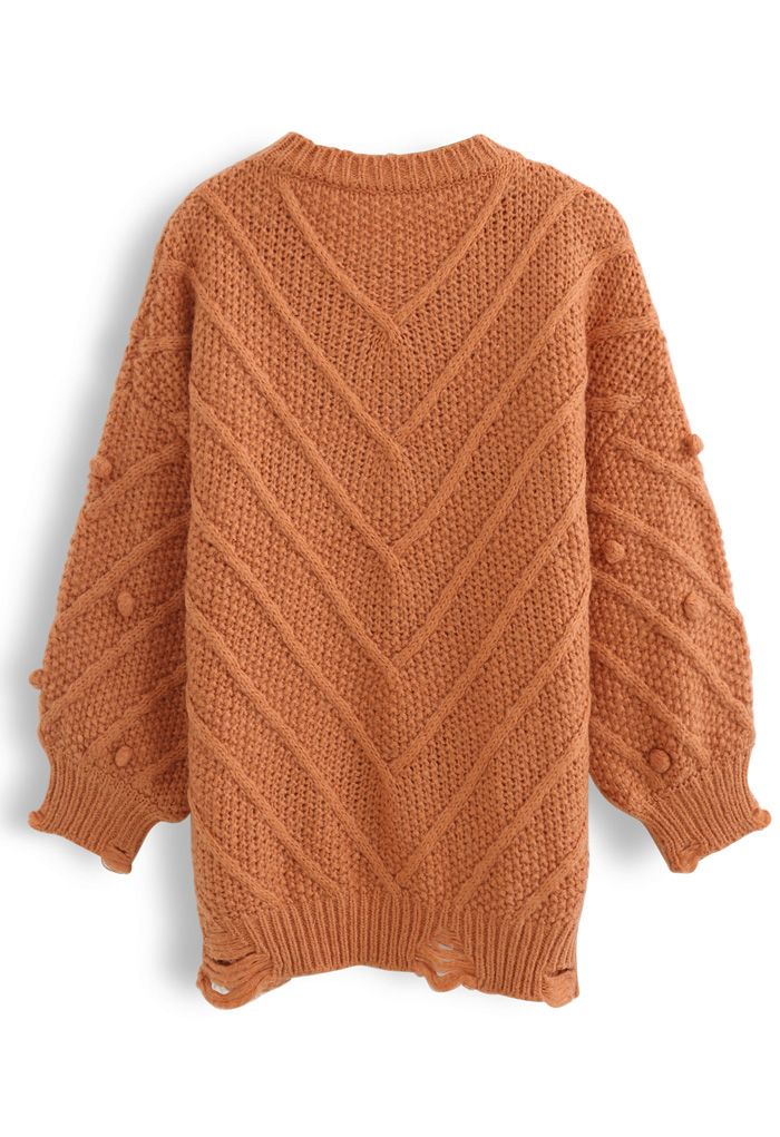 Pull oversize en tricot à ourlet brut et pompons en orange