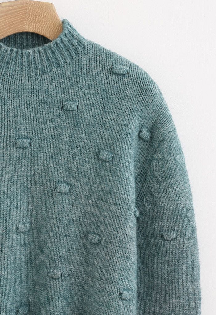 Pull en tricot à col montant et pois 3D en vert