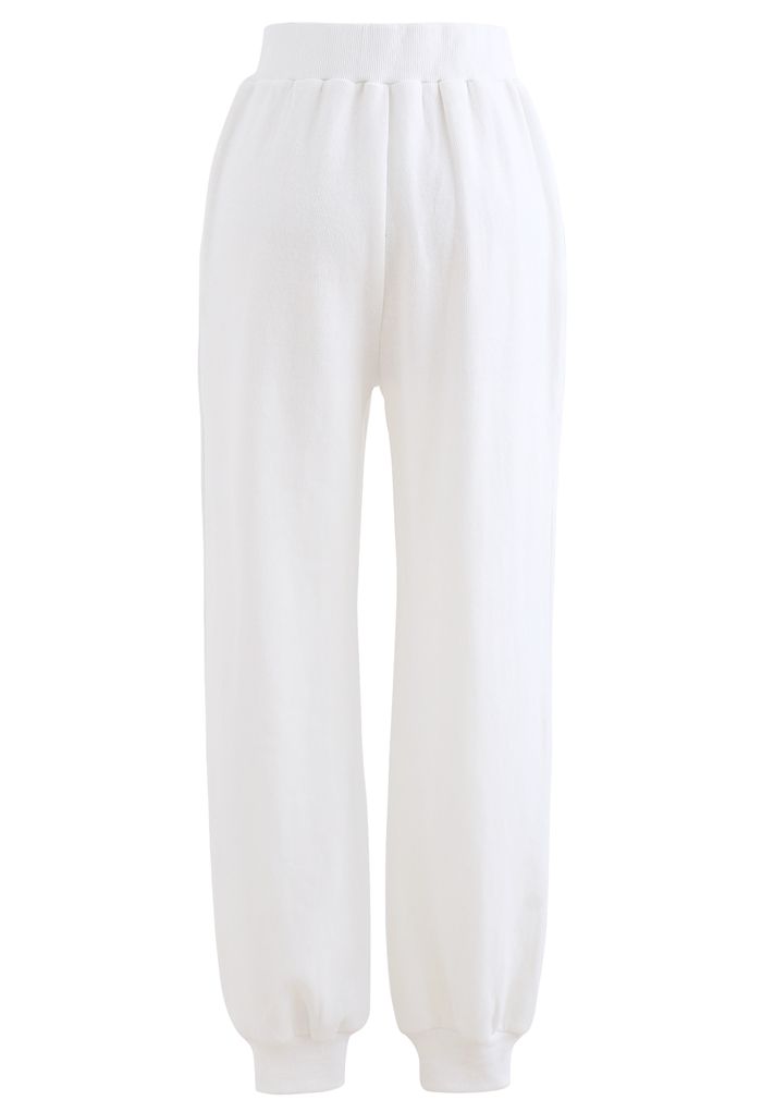Pantalon de jogging zippé avec poches latérales sur le devant en blanc