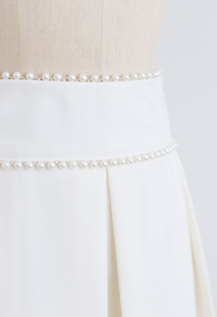 Jupe mi-longue plissée à taille nacrée en blanc