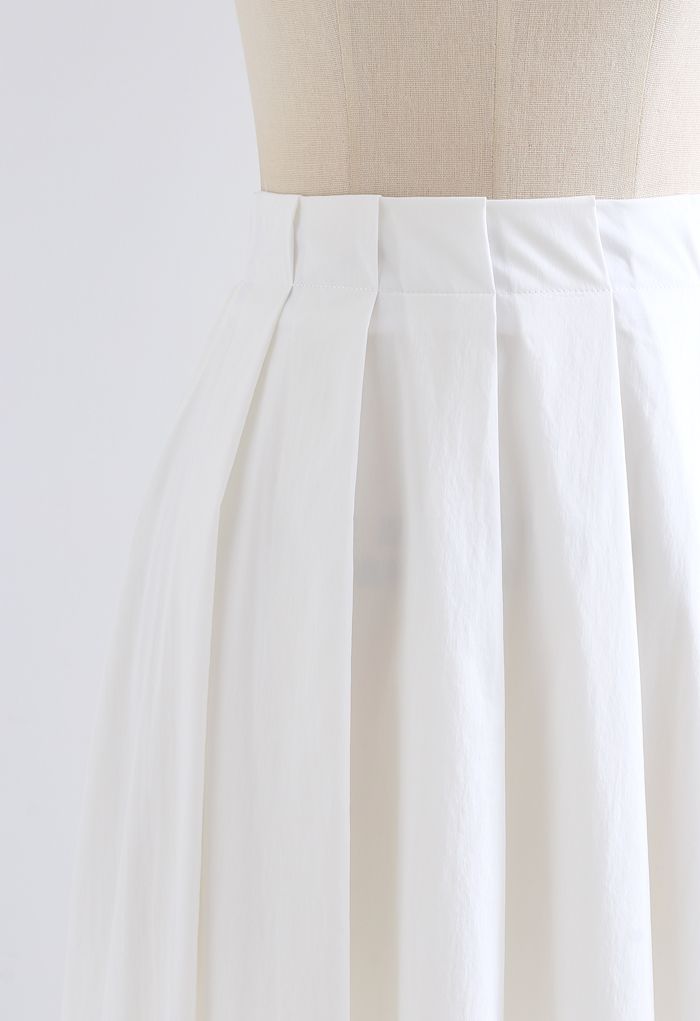 Jupe mi-longue plissée trapèze en coton blanc
