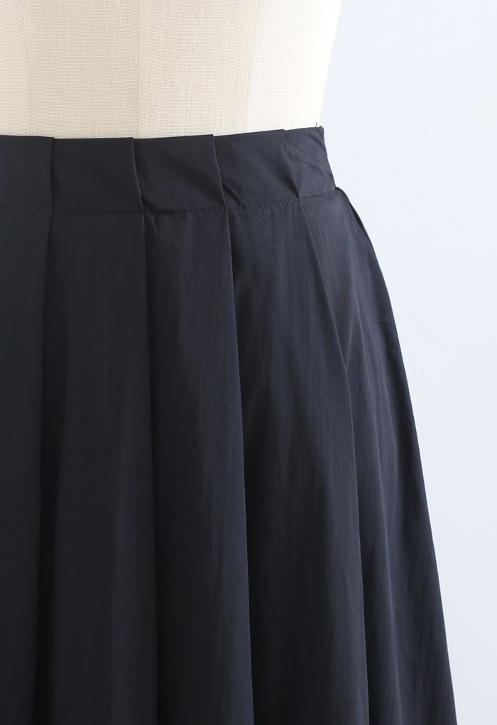 Jupe mi-longue plissée trapèze en coton noir