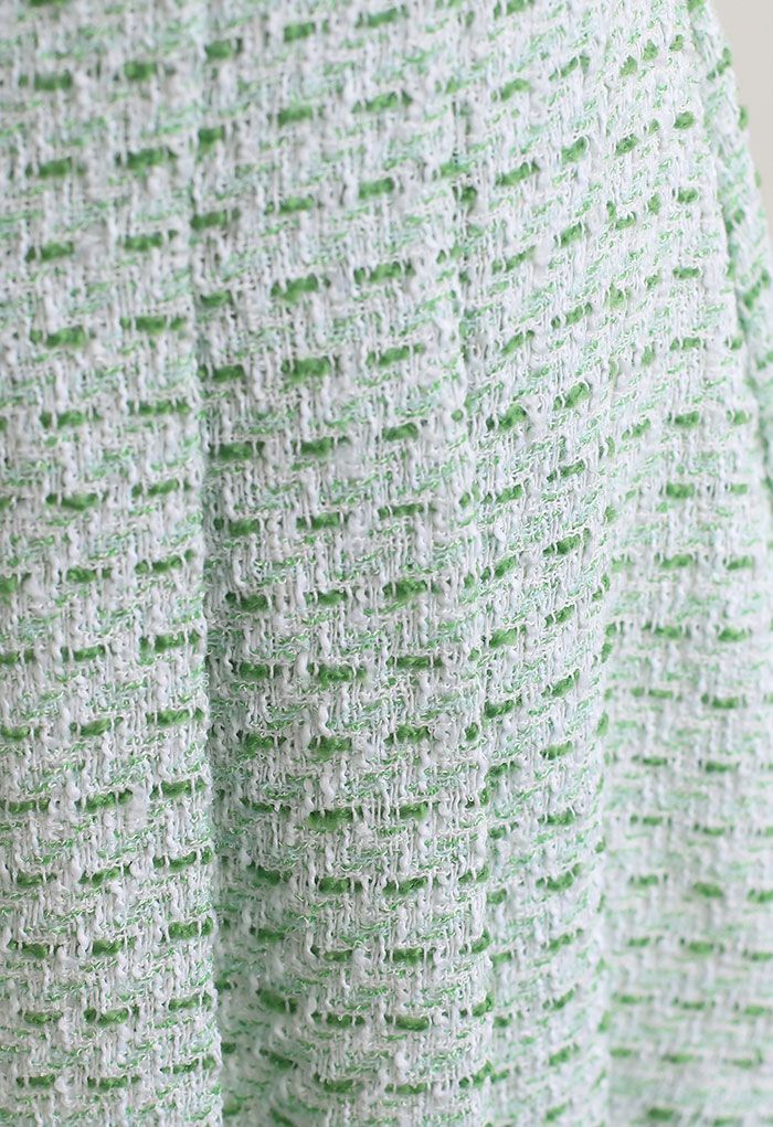 Mini-jupe verte en tweed à ourlet plissé sur le devant