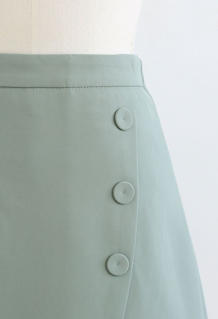 Mini-jupe boutonnée à rabat avec fausse poche en bleu sarcelle