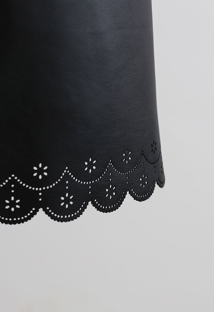 Mini-jupe en faux cuir découpé en noir