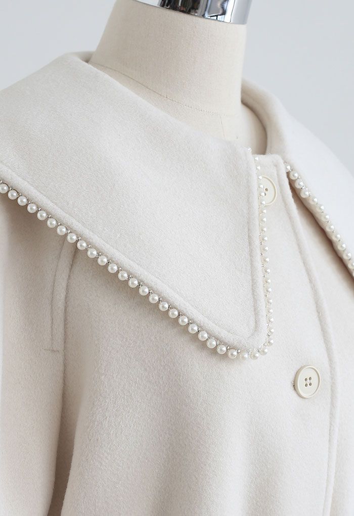 Manteau long boutonné en laine mélangée à bord nacré en crème