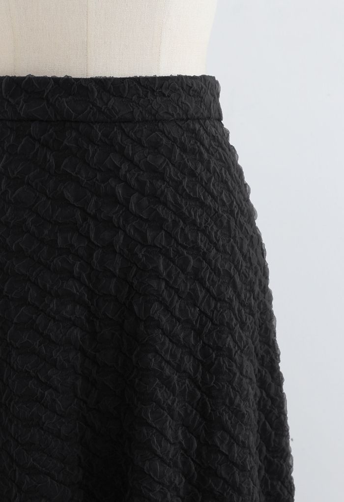 Jupe mi-longue évasée en maille gaufrée en noir