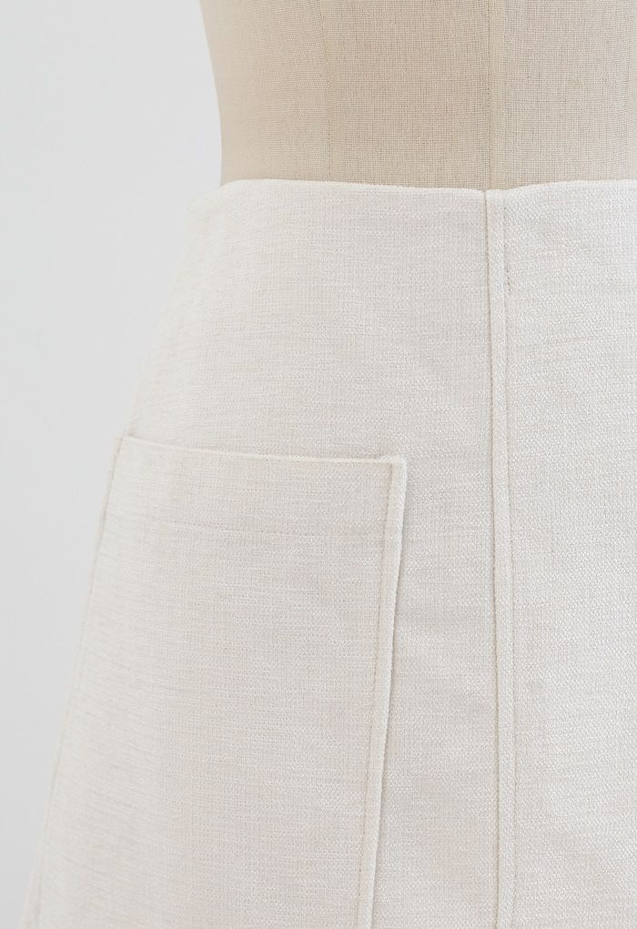 Mini-jupe en tweed scintillant avec poche plaquée en ivoire