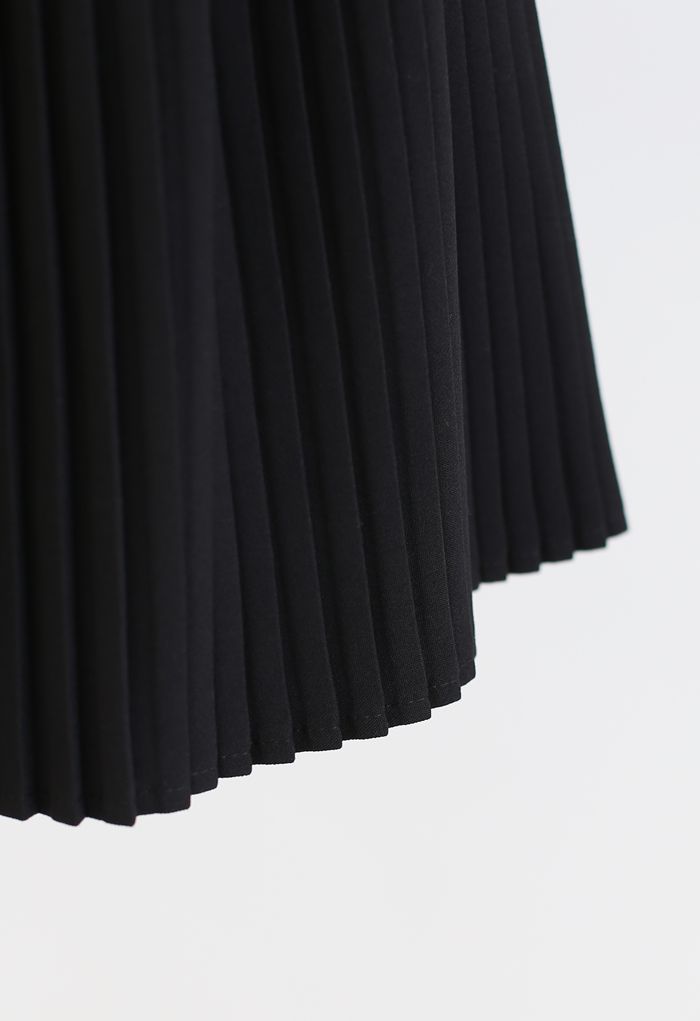 Mini-jupe plissée avec mors de cheval en noir