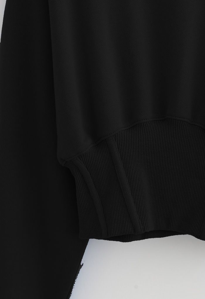 Sweat-shirt court à épaules matelassées en noir