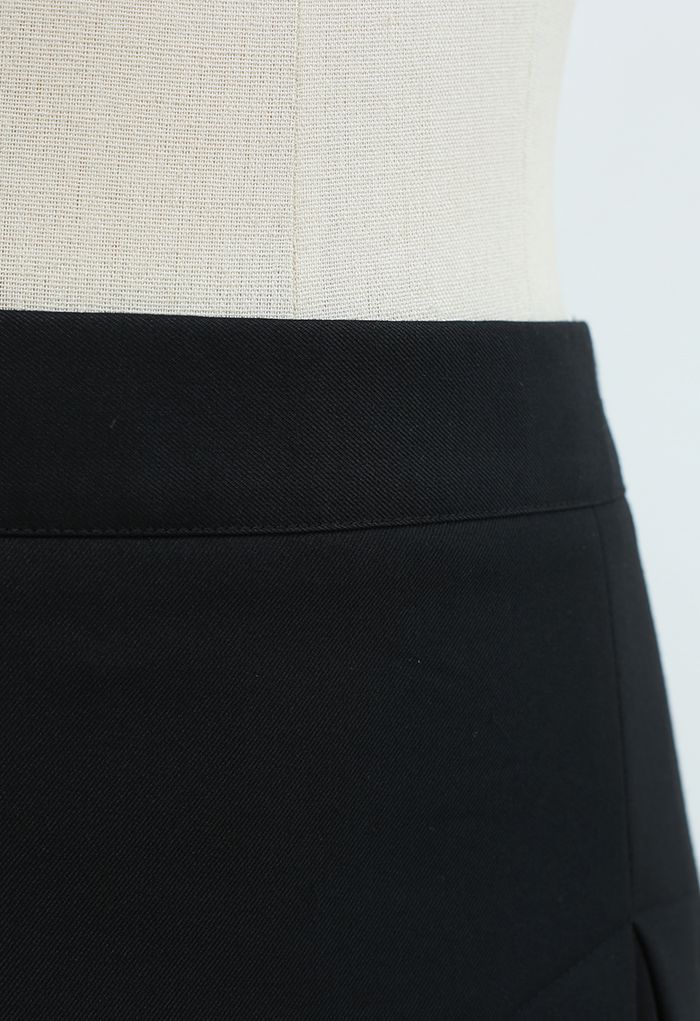 Mini-jupe plissée épissée en noir