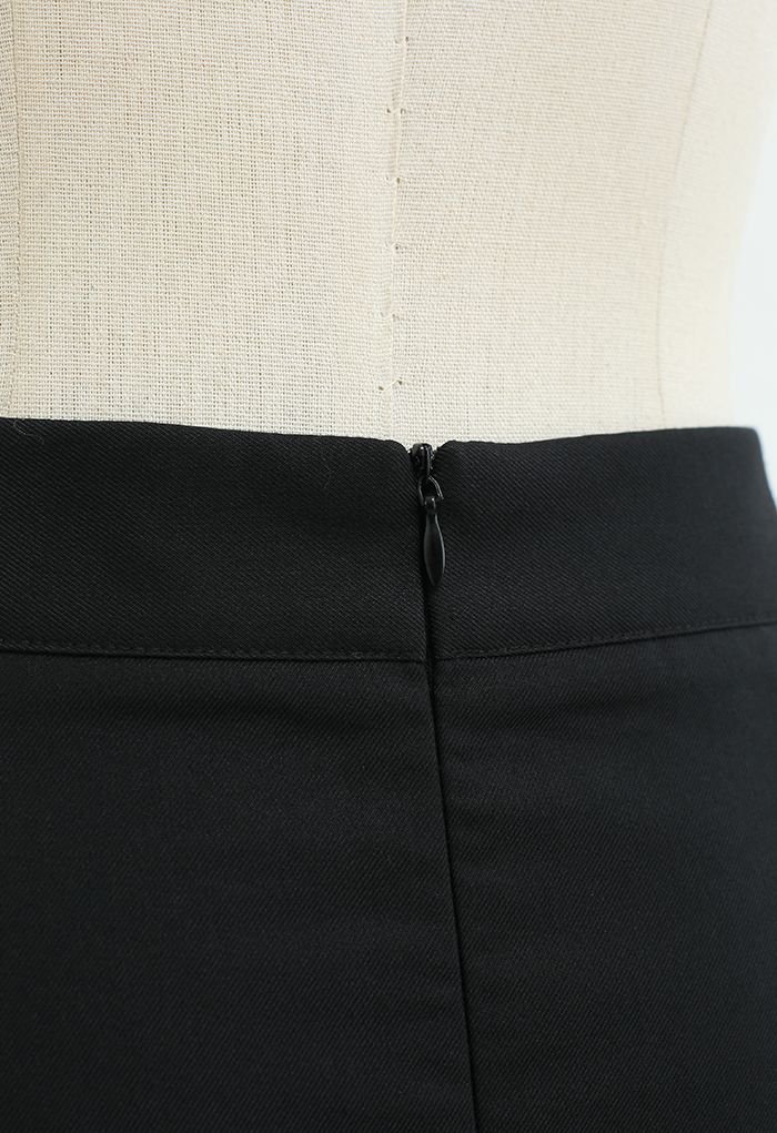Mini-jupe plissée épissée en noir