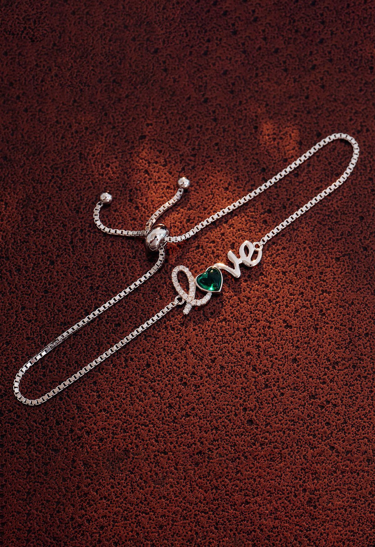 Bracelet émeraude en forme de coeur avec signe d'amour
