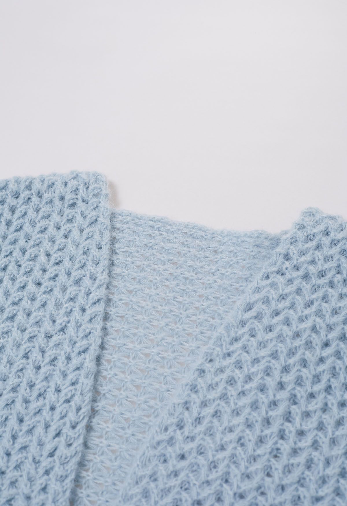 Cardigan en maille ajouré ouvert sur le devant en bleu