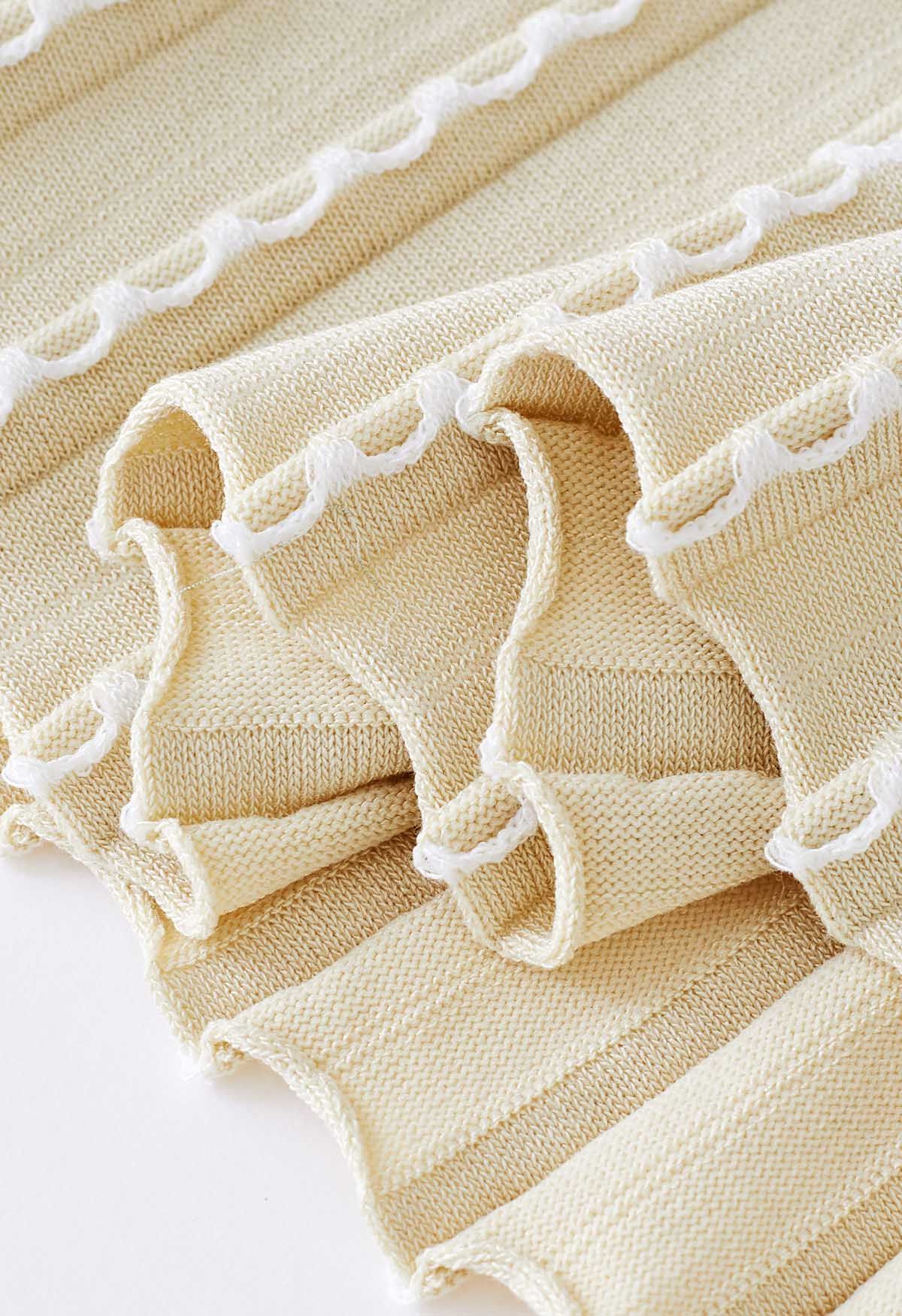 Robe en tricot sans manches à coutures ondulées en crème