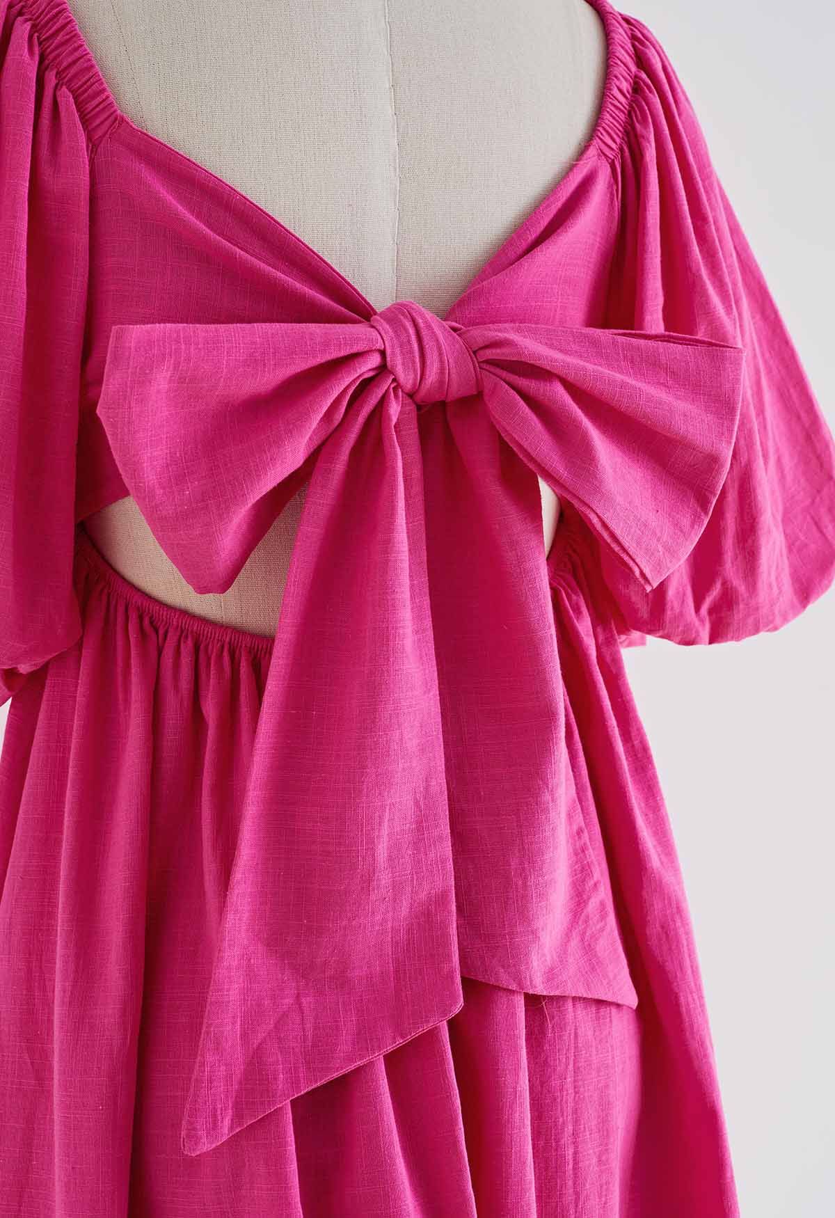 Robe nouée dans le dos à manches bouffantes et encolure carrée en rose vif