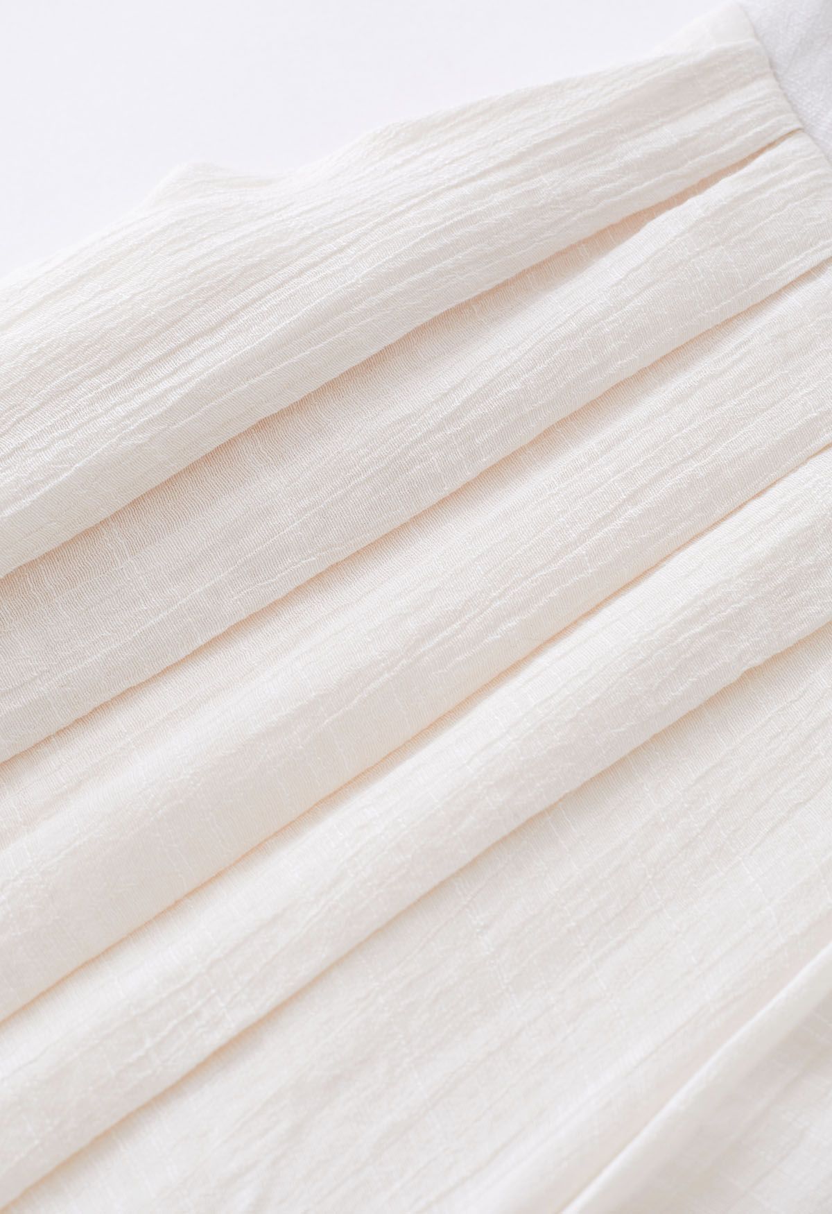 Pantalon large plissé à taille nouée en ivoire
