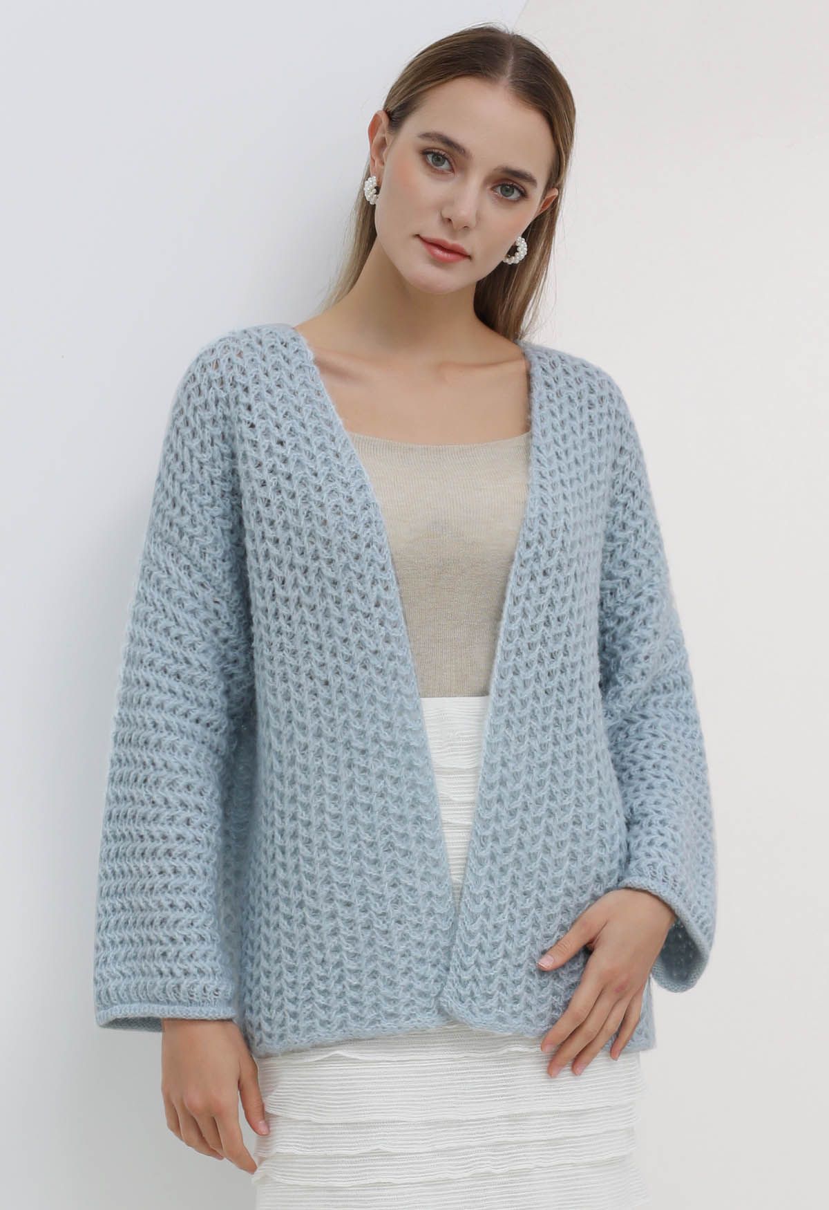 Cardigan en maille ajouré ouvert sur le devant en bleu