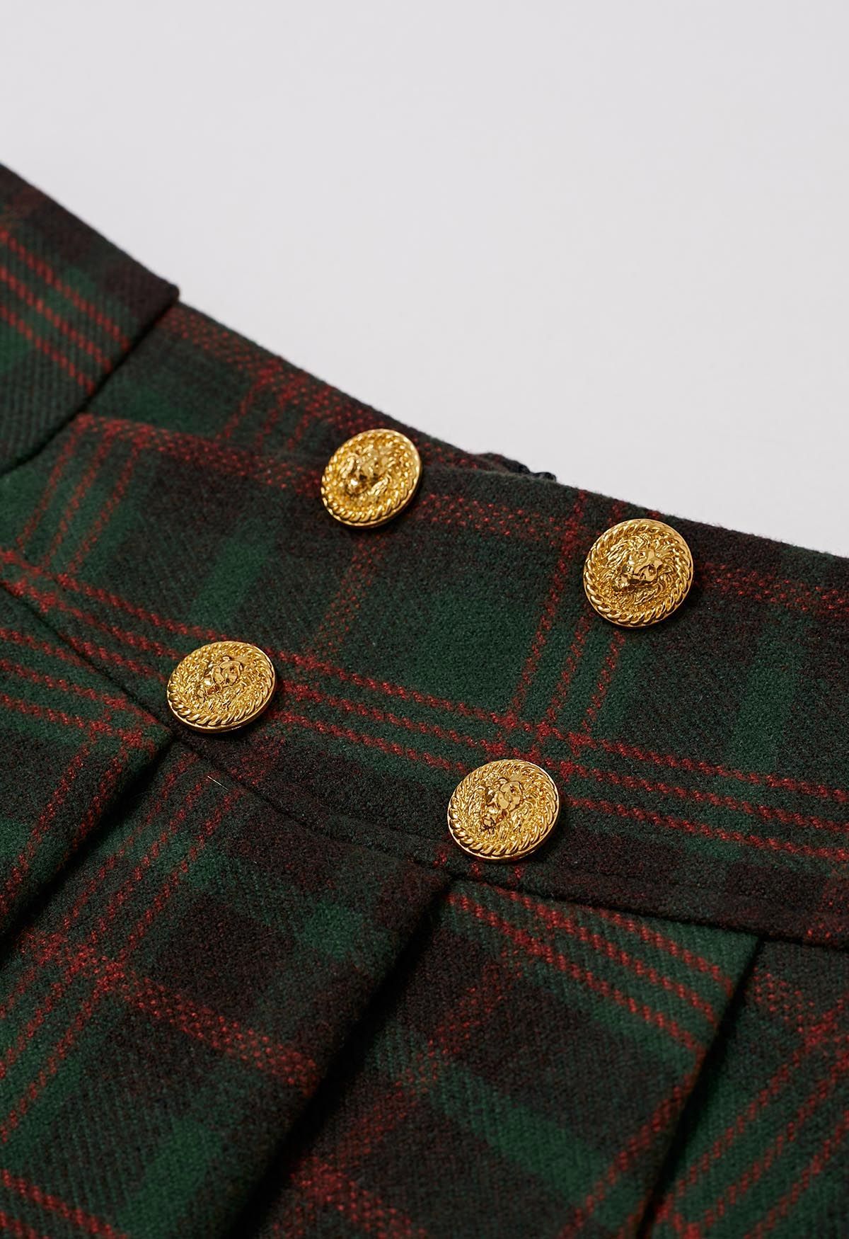 Mini-jupe plissée en laine mélangée à boutons dorés à carreaux verts