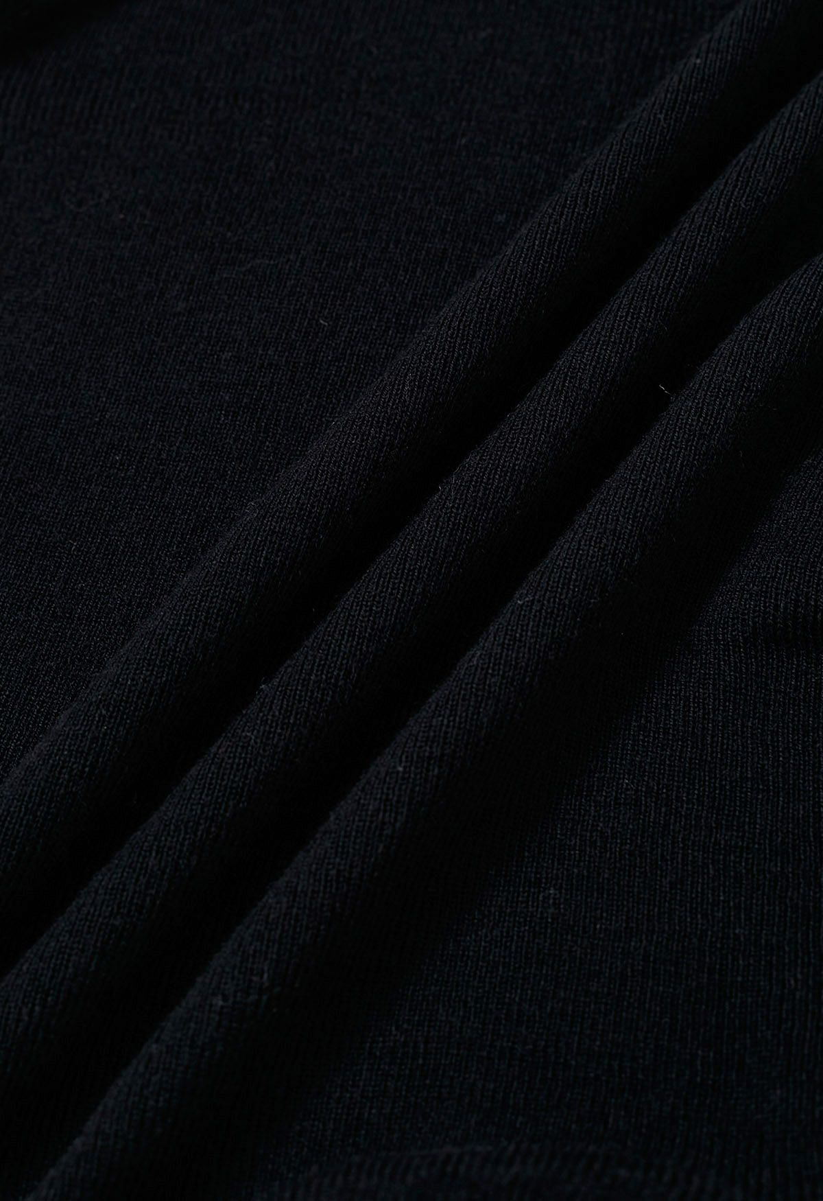 Haut en tricot côtelé à col haut et plis latéraux en noir
