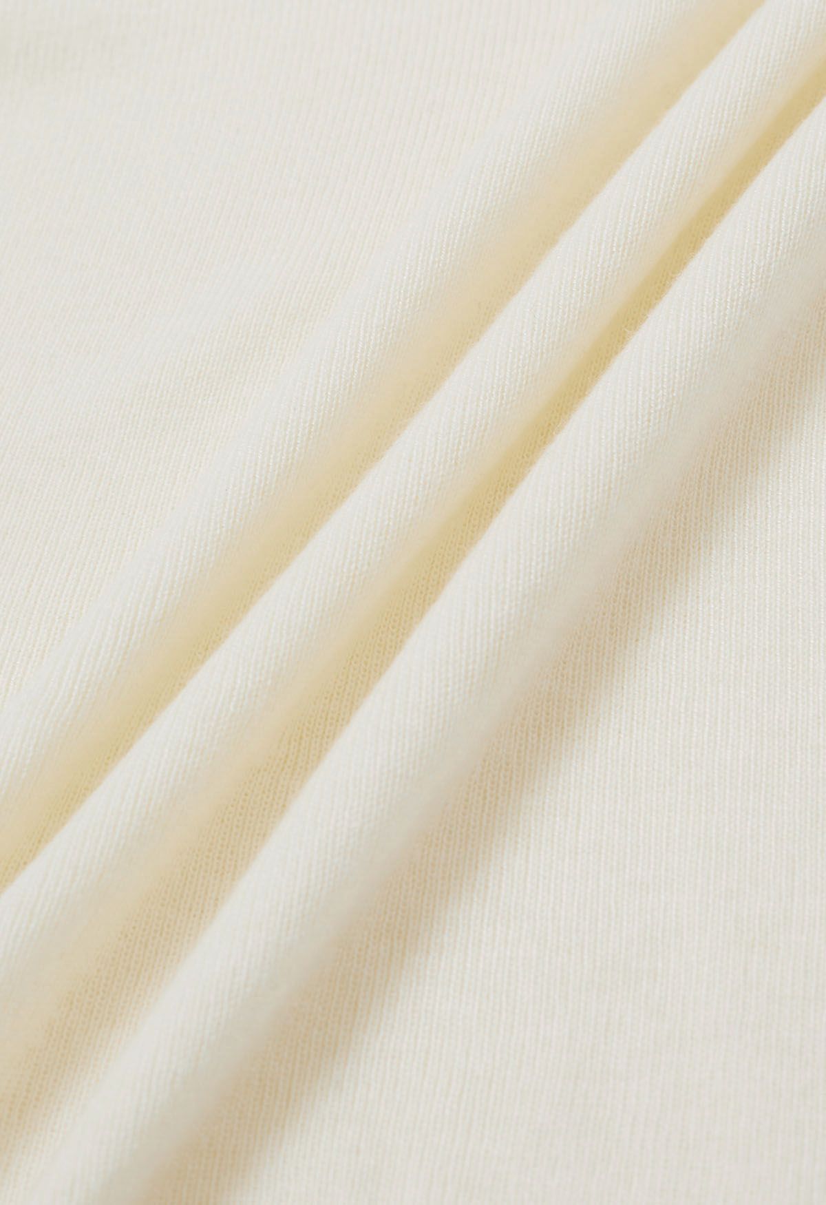 Haut en tricot côtelé à col haut et plis latéraux en crème