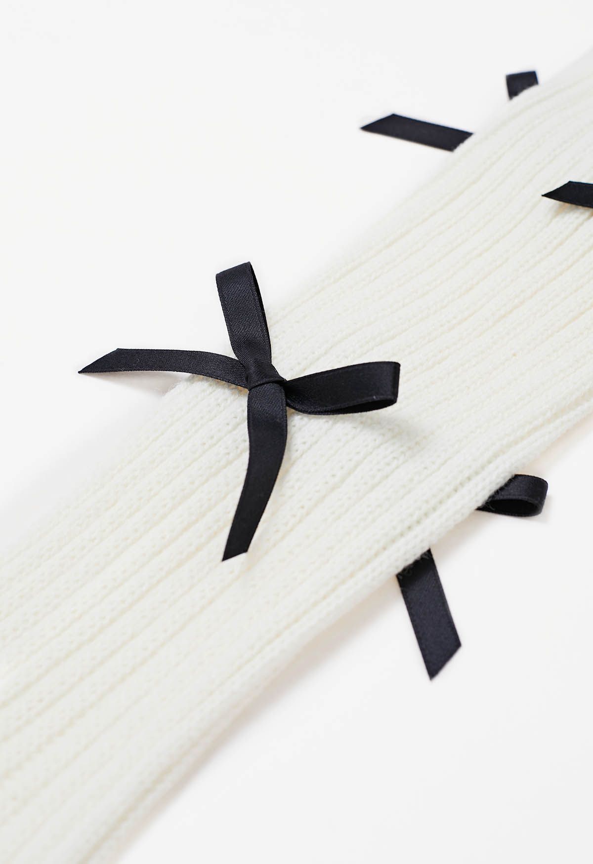 Jambières en tricot à décor de nœud papillon en blanc