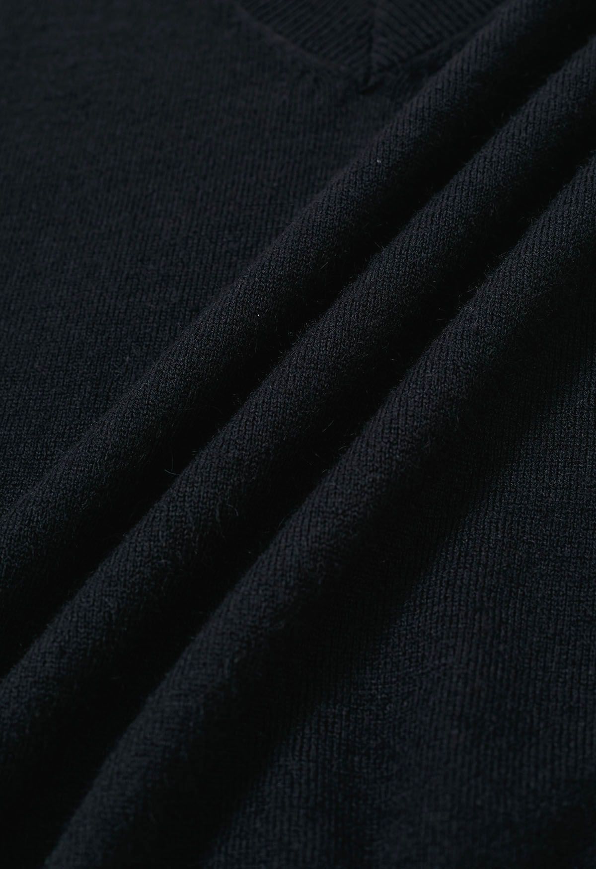Ensemble haut en tricot sans manches à col en V et jupe plissée en noir