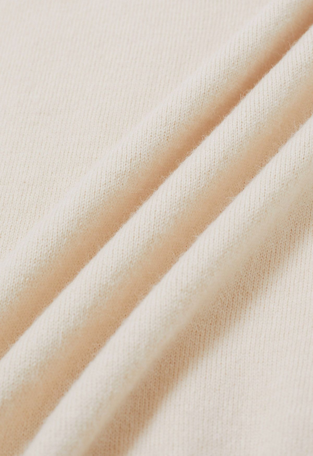 Ensemble haut en tricot sans manches à col en V et jupe plissée en crème