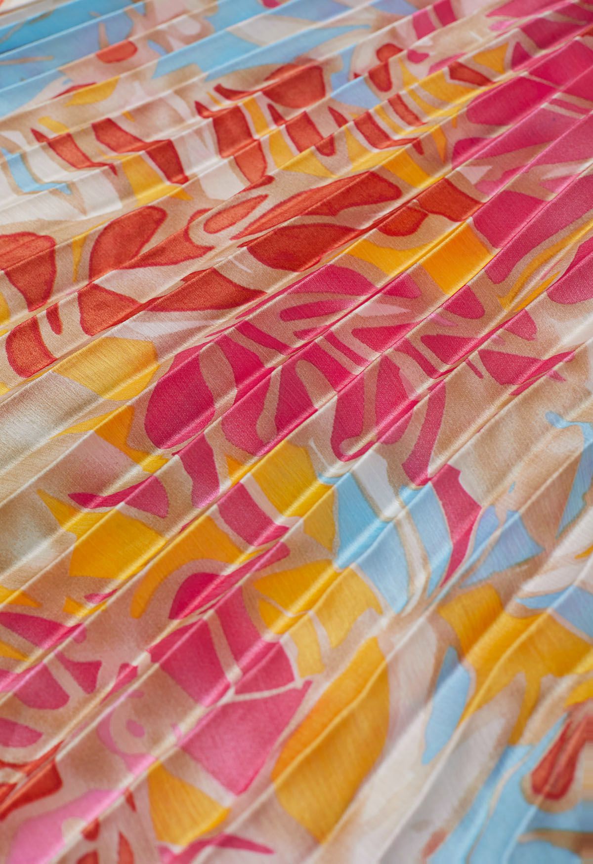 Robe longue asymétrique boutonnée à plis complets et imprimé tropical corail
