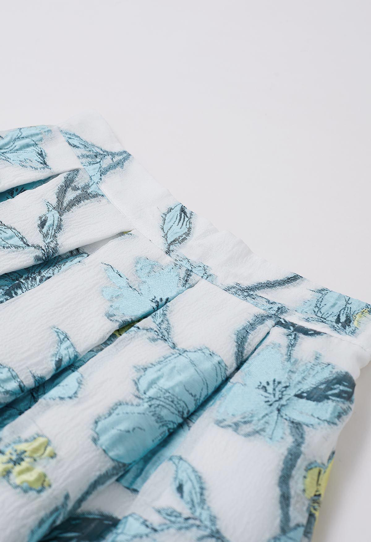 Jupe mi-longue plissée en jacquard floral printanier en bleu