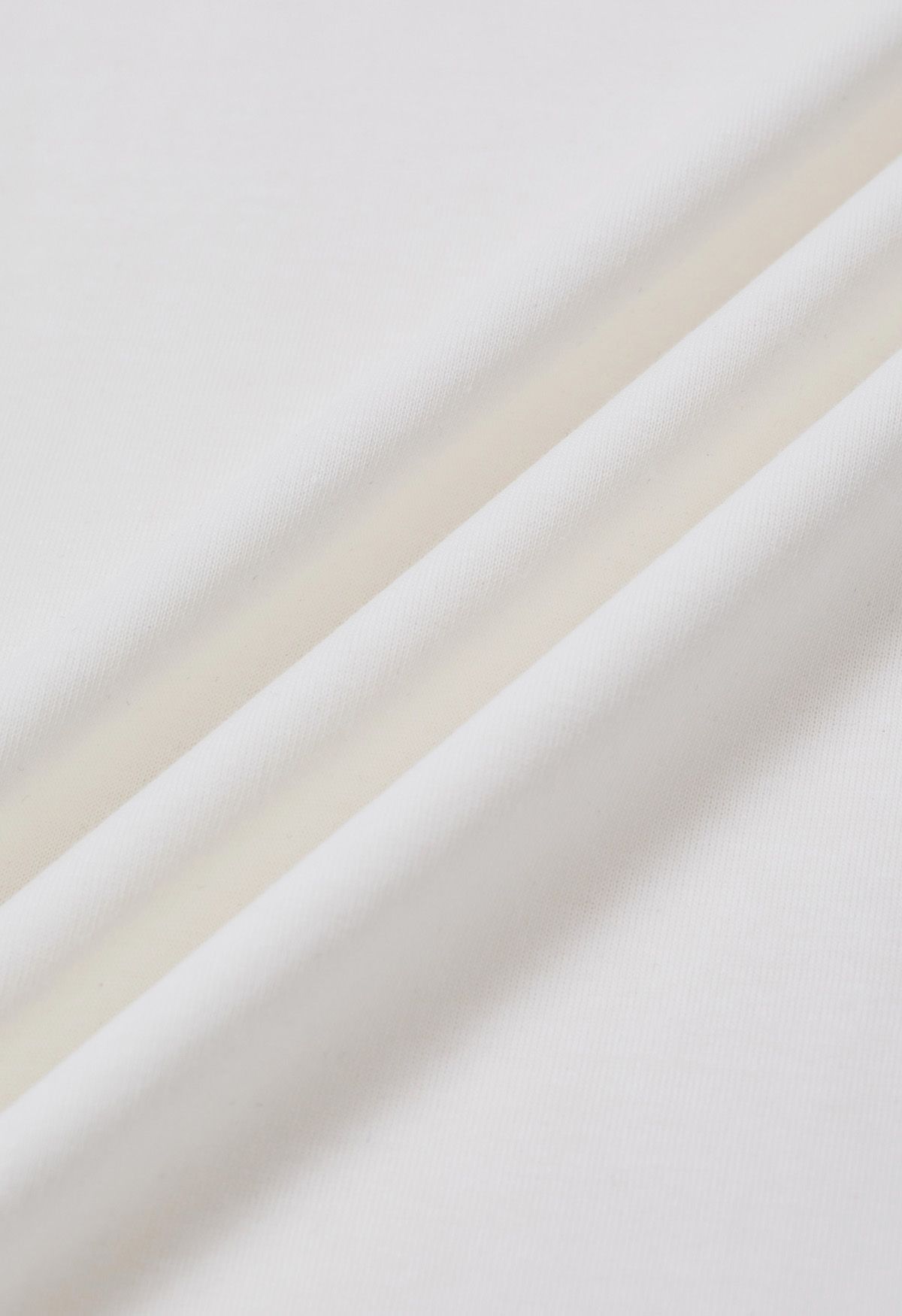 T-shirt orné de perles à motif nœud papillon en blanc