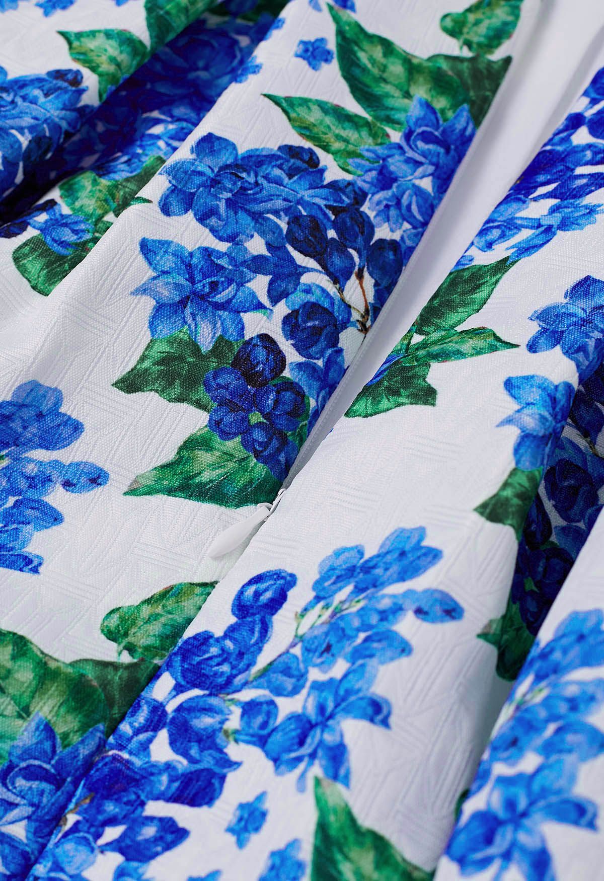 Jupe mi-longue plissée bleue à fleurs Romance