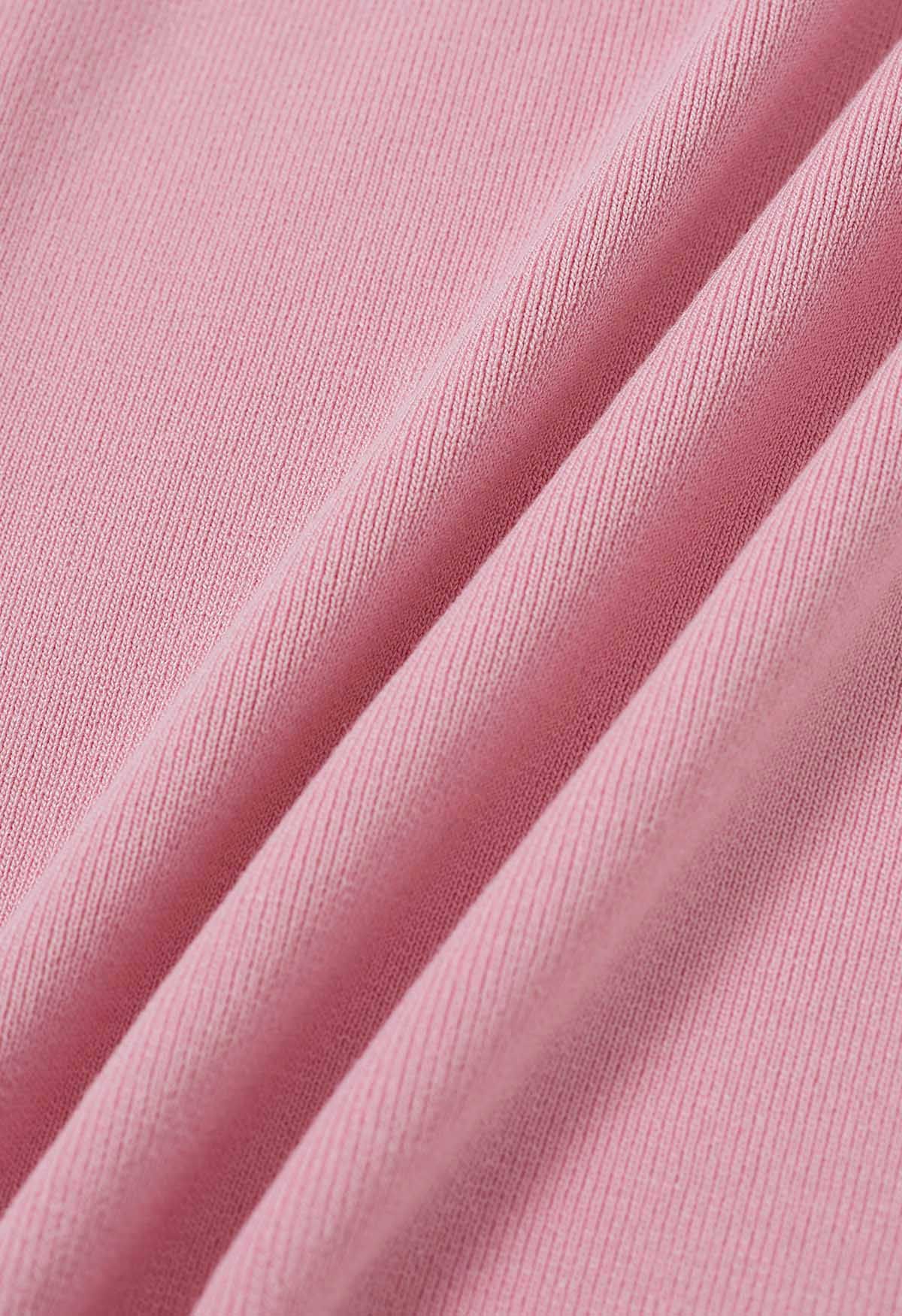 Haut en tricot à une épaule en forme de U à décor métallique en rose