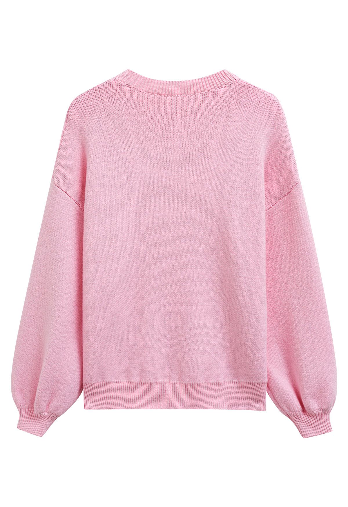 Pull en tricot jacquard à motif ruban et nœud papillon en rose