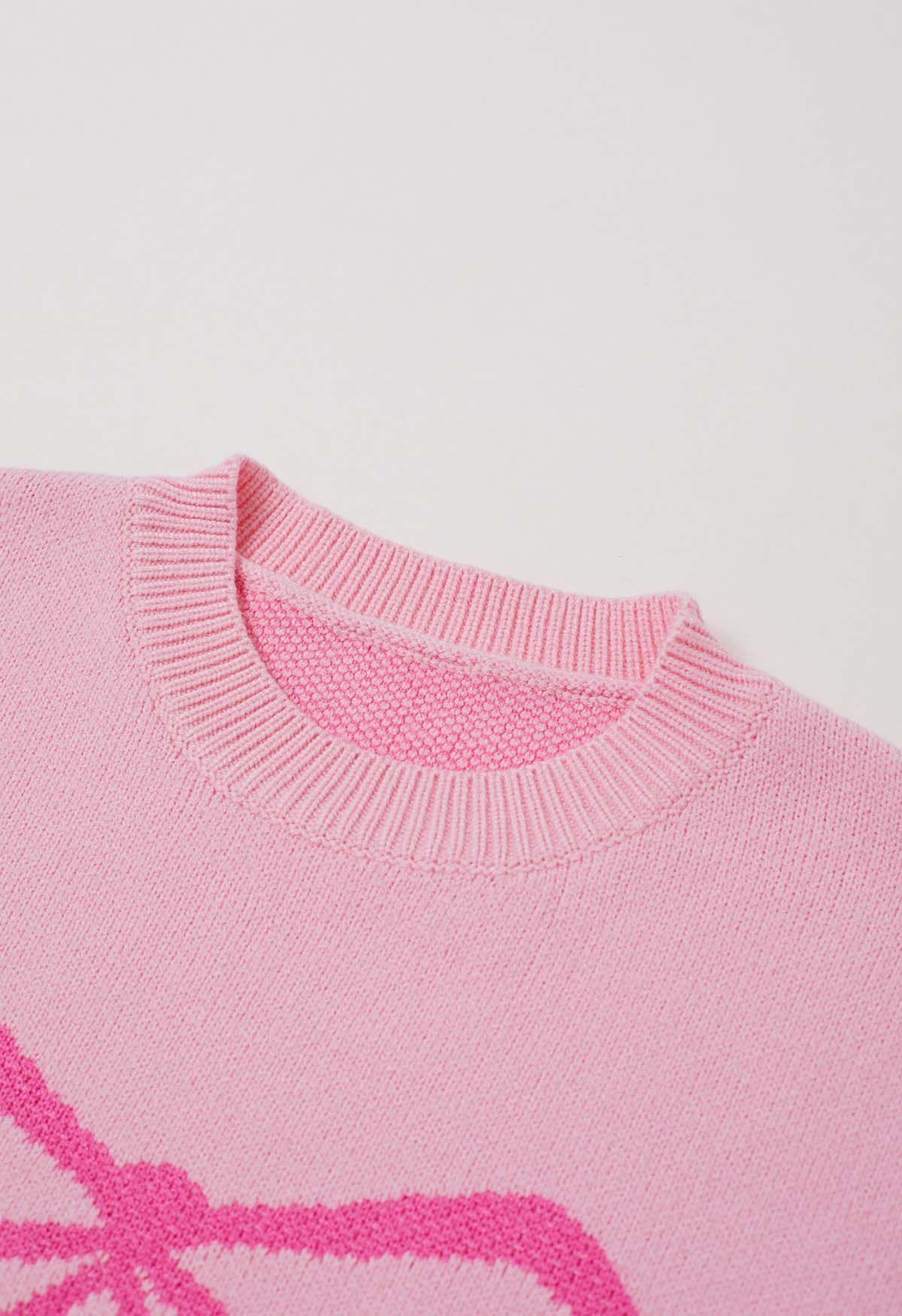 Pull en tricot jacquard à motif ruban et nœud papillon en rose