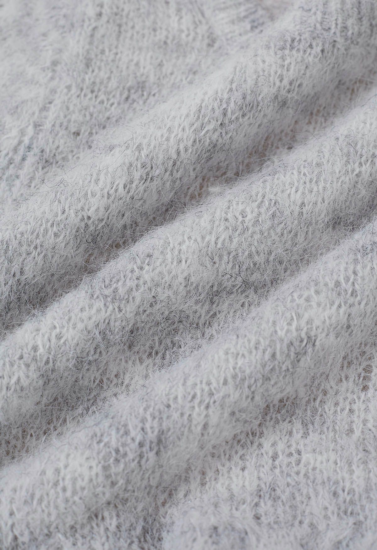 Haut en tricot pelucheux à motif péplum évasé en gris