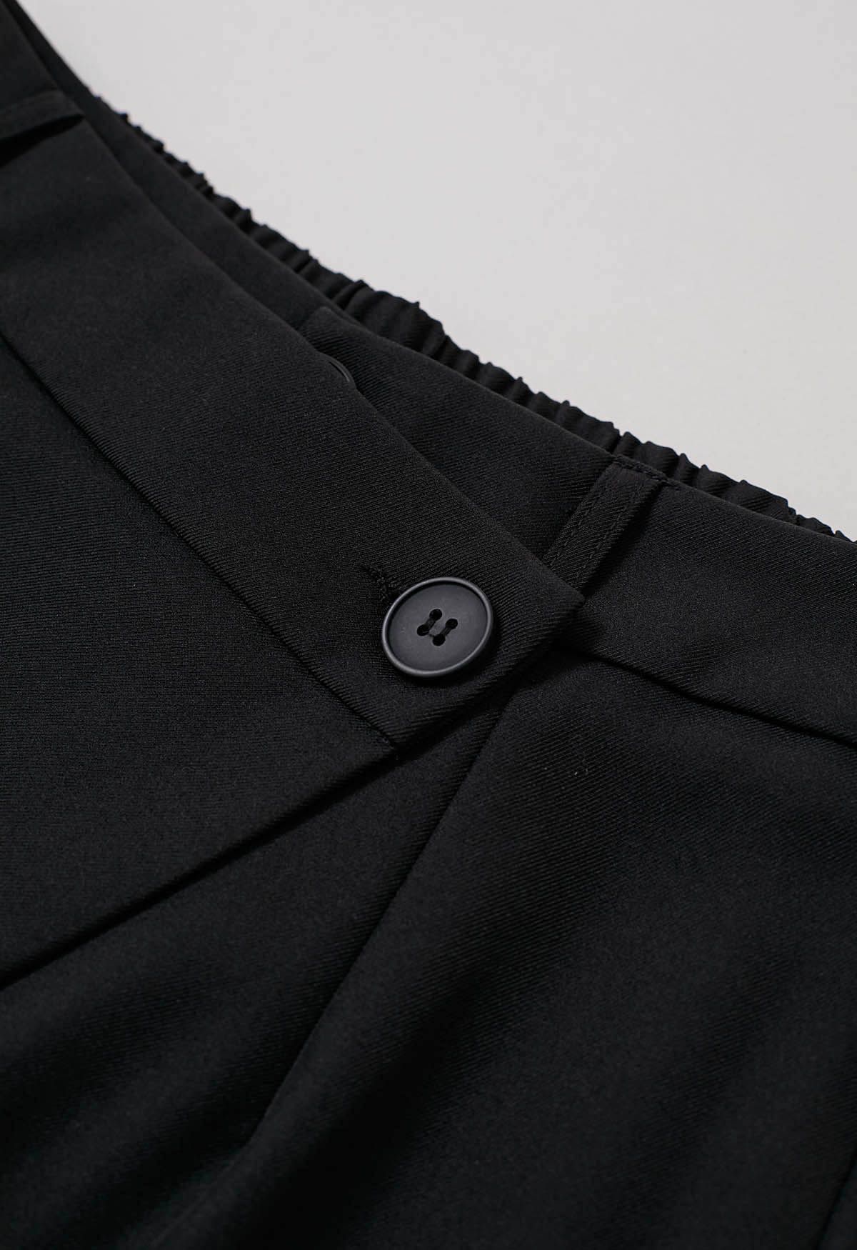 Pantalon coupe droite à boutons et à rabat asymétrique en noir