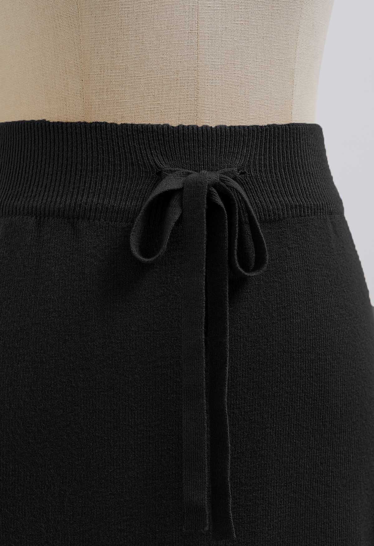 Jupe en tricot noire à fausses poches et taille nouée