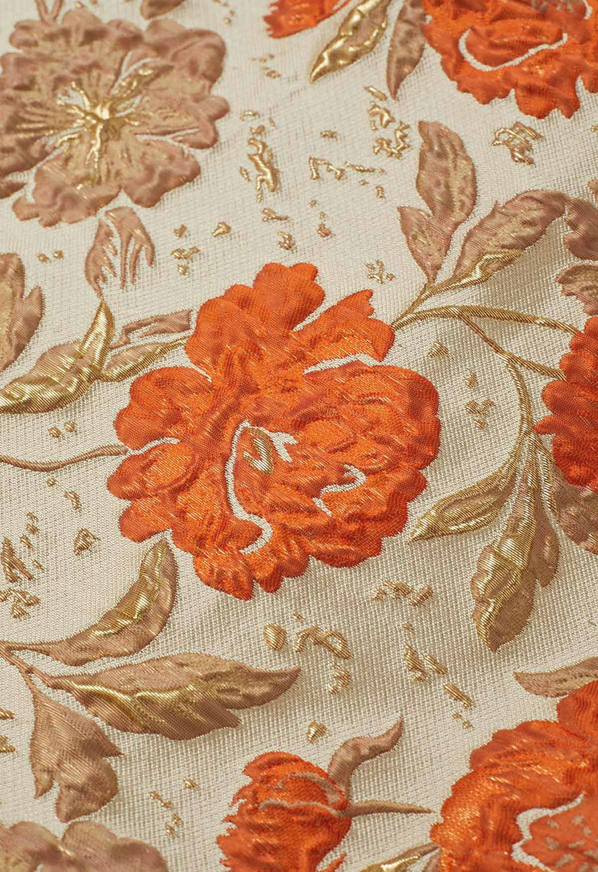 Jupe mi-longue plissée évasée en jacquard fleuri orné de motifs orange