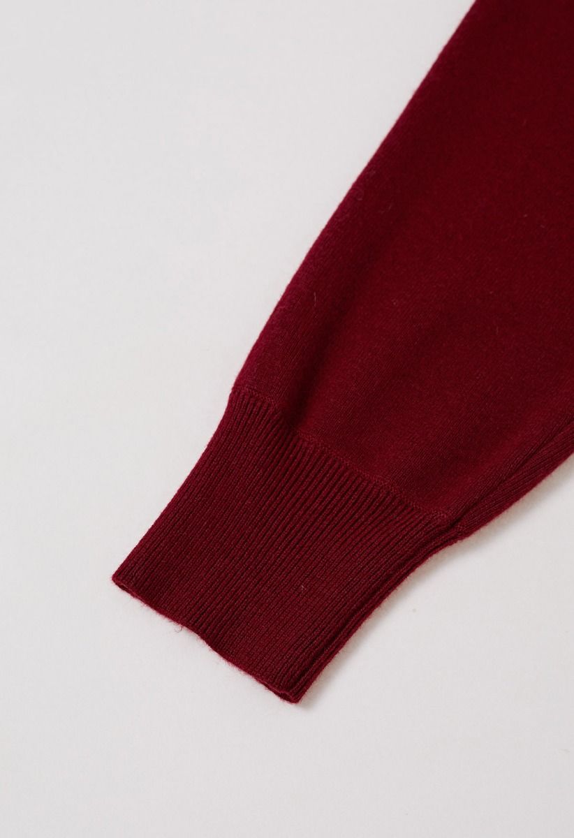 Cardigan minimaliste en tricot côtelé ouvert sur le devant en rouge