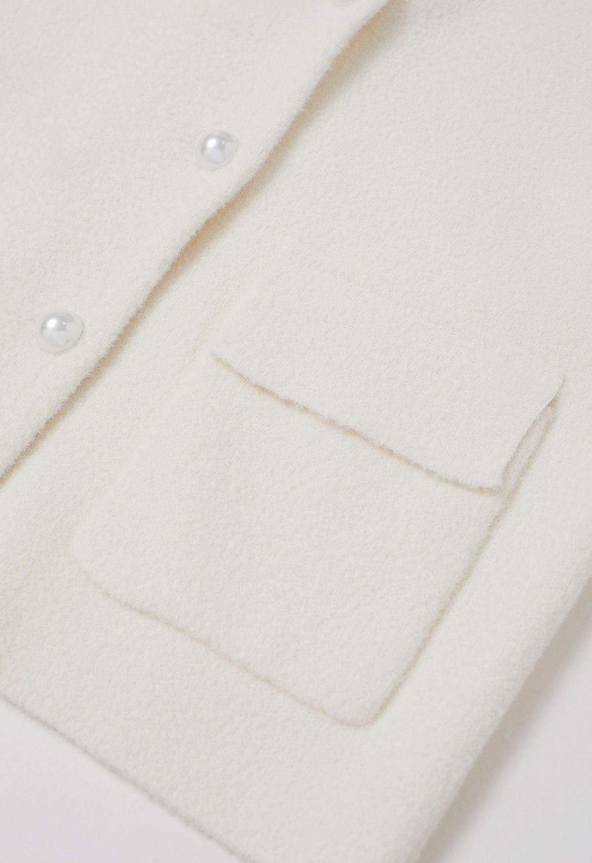 Manteau en tricot boutonné avec poches à rabat et bordure contrastante en blanc