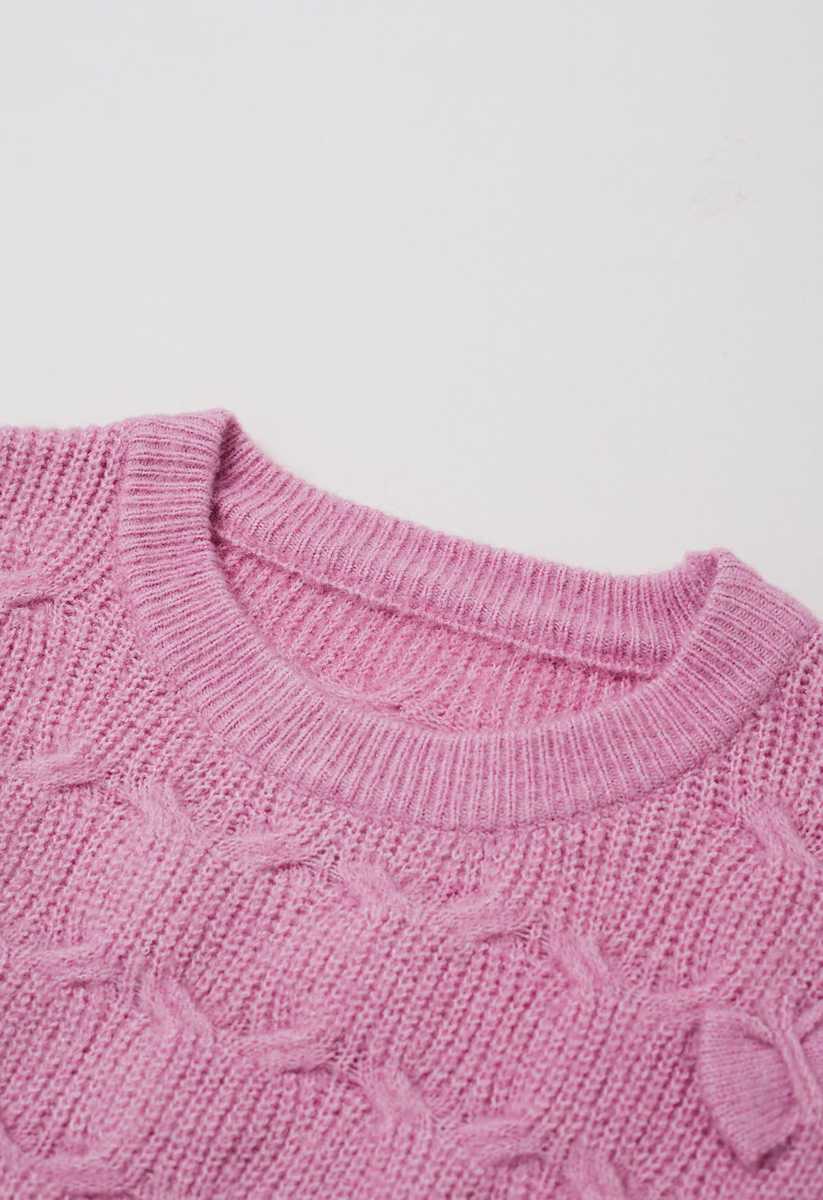 Pull en tricot texturé géométrique à nœud ludique en rose