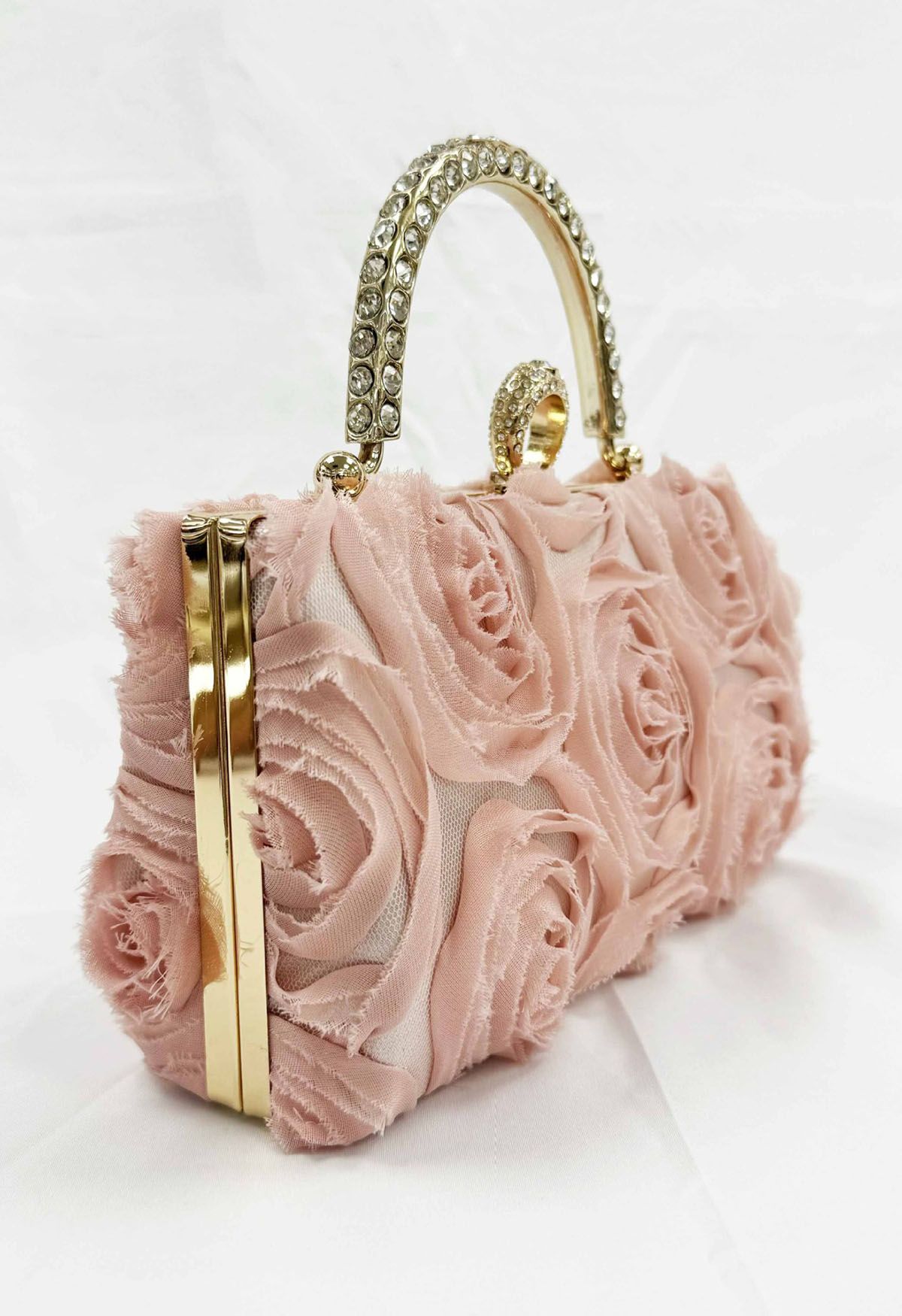 Pochette opulente avec poignée en strass en rose