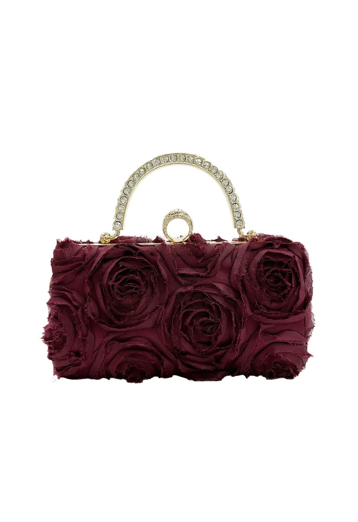 Pochette opulente avec poignée en strass rose en bordeaux