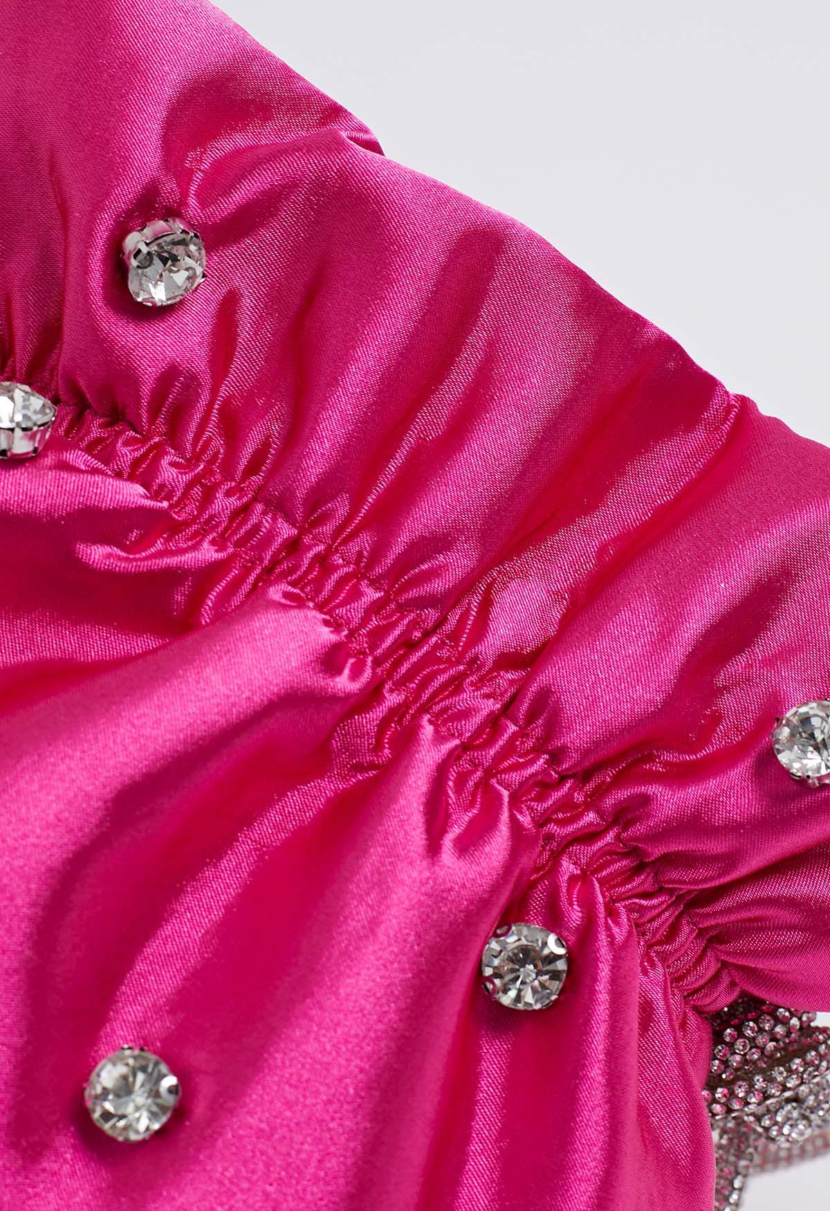 Sac à bandoulière avec cordon de serrage et décoration en strass en rose vif