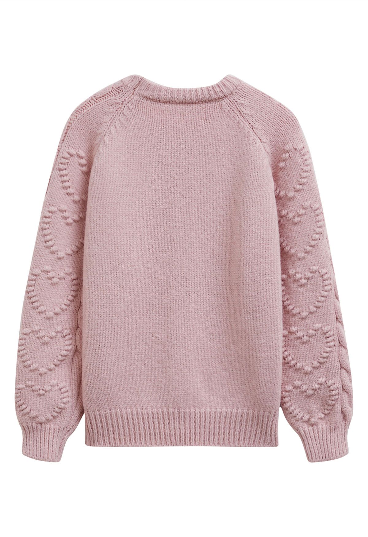 Pull en maille torsadée avec motif cœur en relief en rose clair