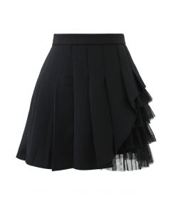 Mini-jupe plissée à empiècements en maille noire